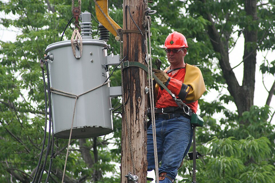 wikipedia image of lineman changing power transformer